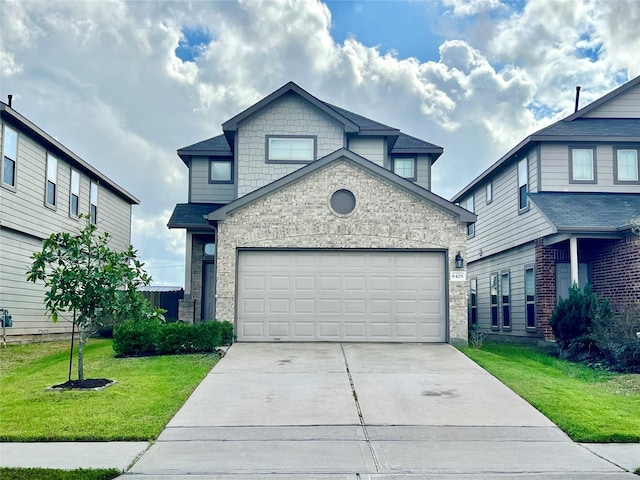 view of front of home with a garage and a front yard