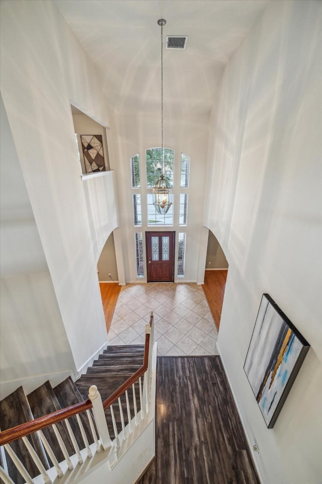 foyer entrance featuring hardwood / wood-style flooring and a chandelier