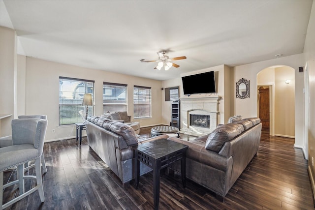 living room with ceiling fan and dark hardwood / wood-style floors