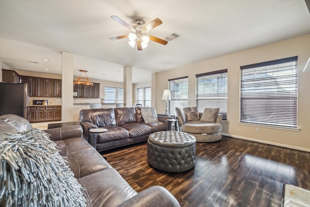 living room featuring dark hardwood / wood-style floors and ceiling fan