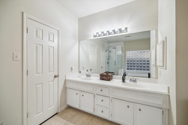 bathroom with vanity, a shower with shower door, and tile patterned floors