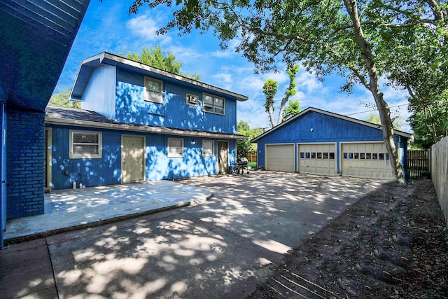2713 John St, La Marque, TX 77568 - view of front of home featuring fence, an outbuilding, and a detached garage