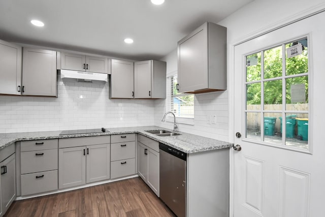 2713 John St, La Marque, TX 77568 - kitchen with stainless steel dishwasher, black electric cooktop, under cabinet range hood, a sink, and gray cabinetry