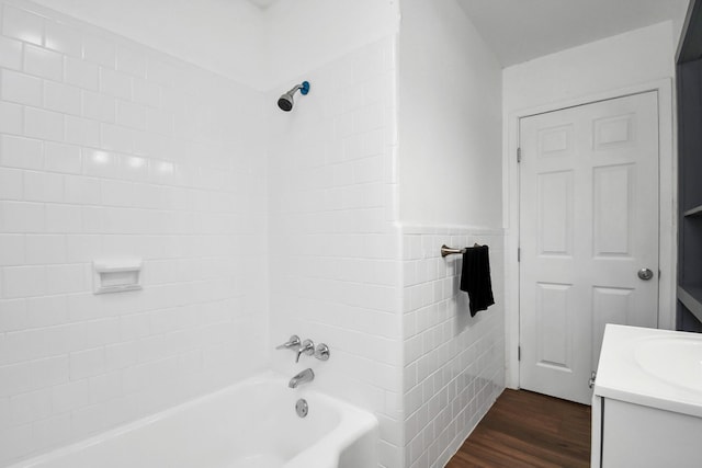 2713 John St, La Marque, TX 77568 - full bath with vanity, wood finished floors, shower / bathtub combination, tile walls, and a wainscoted wall