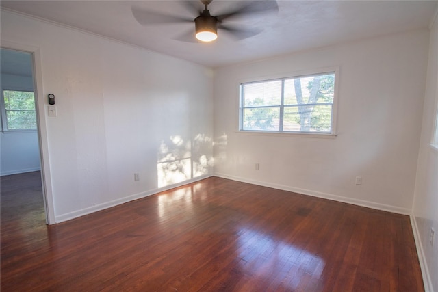 2713 John St, La Marque, TX 77568 - empty room with a ceiling fan, baseboards, and dark wood-style floors