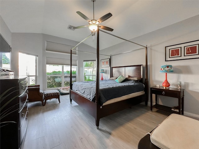 bedroom featuring lofted ceiling, ceiling fan, and light hardwood / wood-style flooring