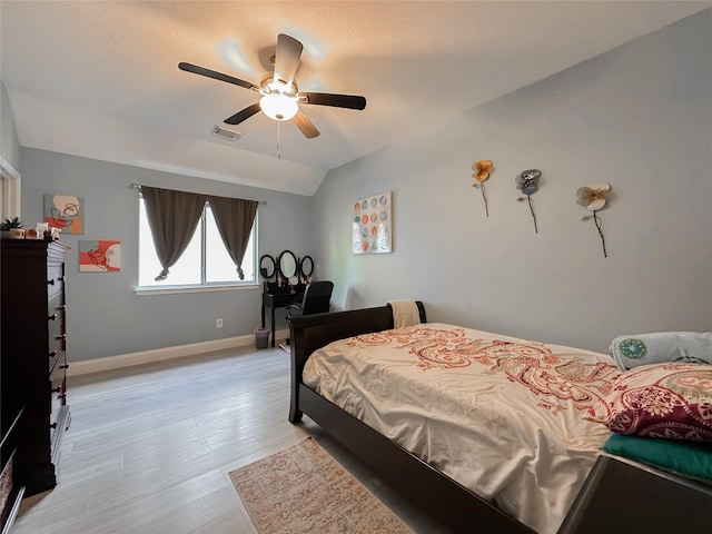 bedroom featuring vaulted ceiling, light hardwood / wood-style floors, and ceiling fan