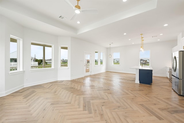 unfurnished living room with light parquet floors and ceiling fan