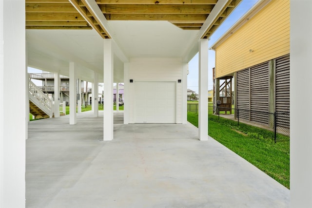 view of patio / terrace featuring a garage and a carport