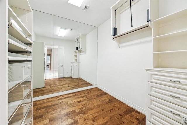 spacious closet featuring dark wood-type flooring