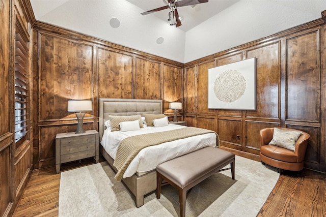 bedroom featuring lofted ceiling, ceiling fan, and light hardwood / wood-style flooring