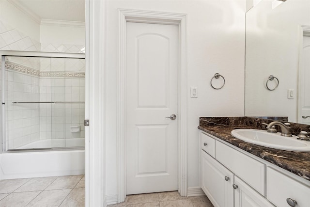 bathroom featuring crown molding, vanity, bath / shower combo with glass door, and tile patterned flooring