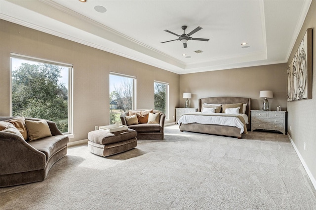 bedroom with light carpet, crown molding, and a tray ceiling