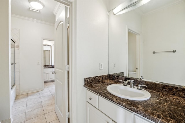 bathroom featuring ornamental molding, combined bath / shower with glass door, tile patterned floors, and vanity