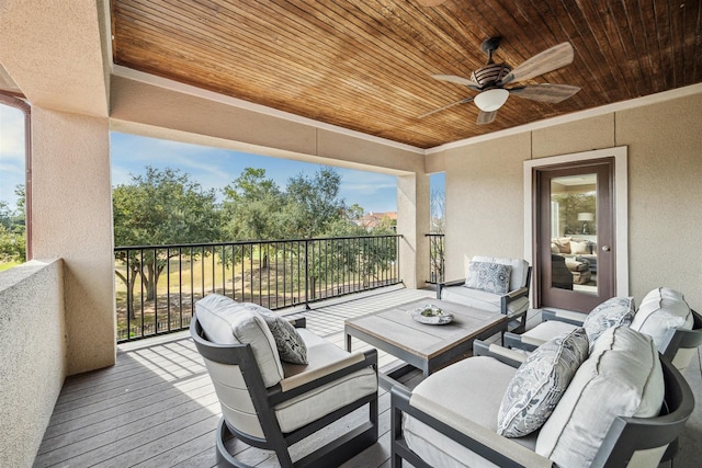 wooden terrace featuring an outdoor hangout area and ceiling fan