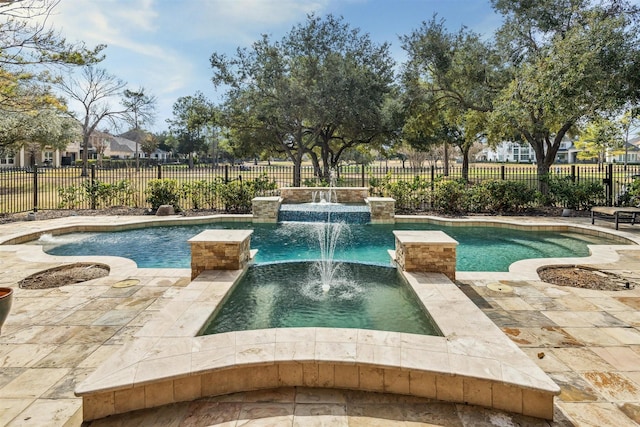 view of pool with pool water feature and a hot tub