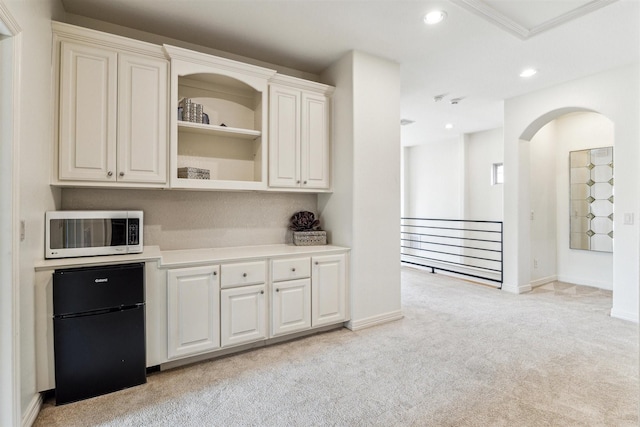 bar featuring black refrigerator and light colored carpet