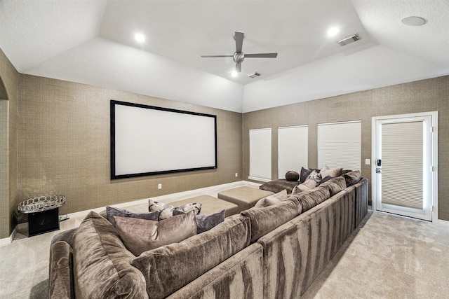 cinema with vaulted ceiling, light colored carpet, and ceiling fan