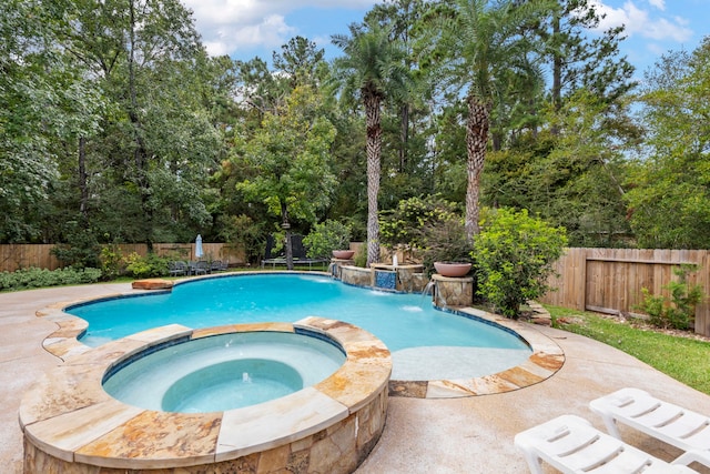 view of swimming pool featuring an in ground hot tub and a patio