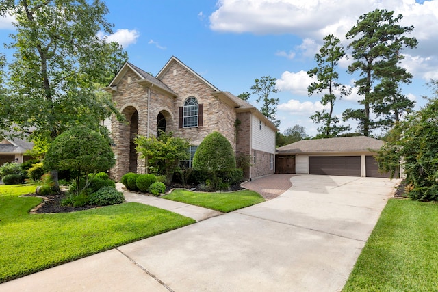 view of front of property with a garage and a front lawn