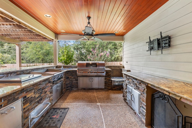 view of patio featuring area for grilling, sink, and ceiling fan