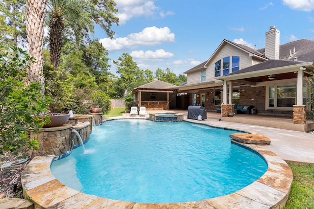 view of swimming pool featuring an in ground hot tub, pool water feature, ceiling fan, and a patio area