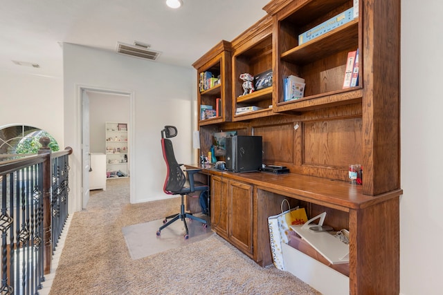 office area with built in desk and light carpet