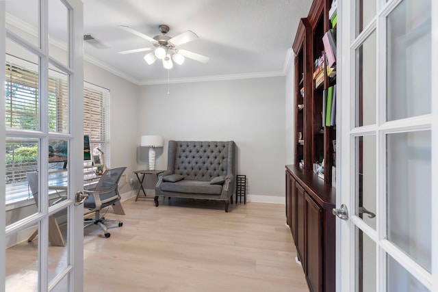 office featuring crown molding, french doors, ceiling fan, and light wood-type flooring