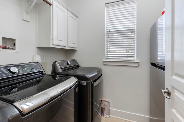 laundry room featuring cabinets and washing machine and clothes dryer