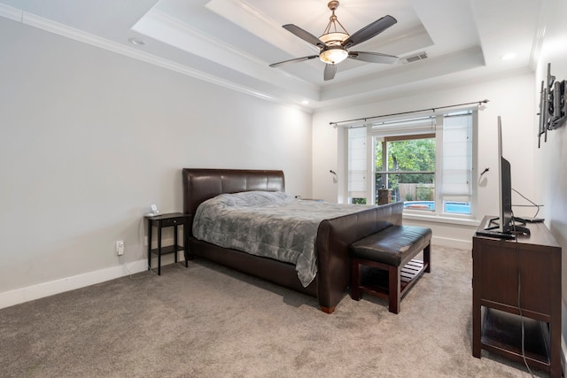 carpeted bedroom with ornamental molding, a raised ceiling, and ceiling fan