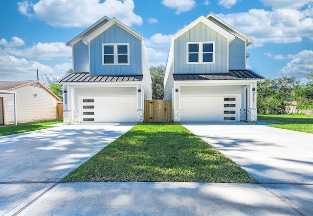 modern farmhouse featuring a garage and a front lawn