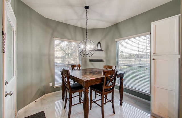 dining area featuring plenty of natural light and a notable chandelier