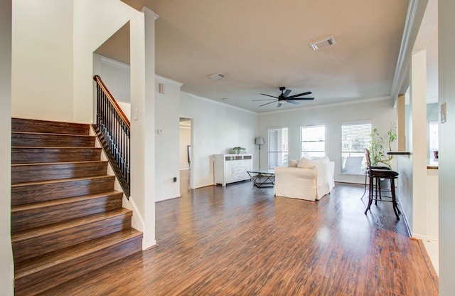 living room with ceiling fan, ornamental molding, and dark hardwood / wood-style floors