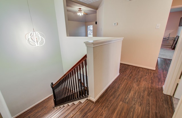 hallway with dark hardwood / wood-style floors and a notable chandelier