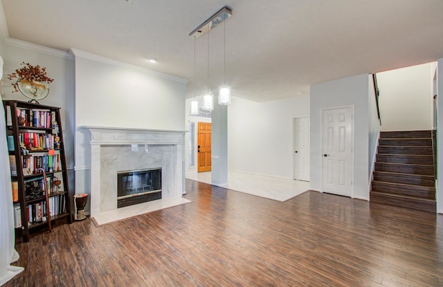 unfurnished living room featuring ornamental molding, dark hardwood / wood-style floors, and a fireplace