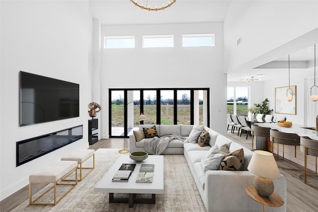 living room with hardwood / wood-style floors and a chandelier