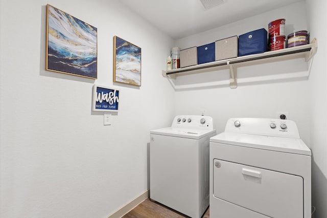 laundry room featuring hardwood / wood-style flooring and washing machine and clothes dryer