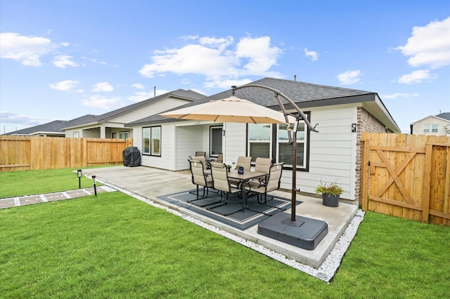 rear view of property with a yard and a patio area