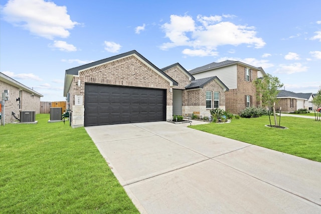 view of front of home with a garage, a front yard, and central air condition unit