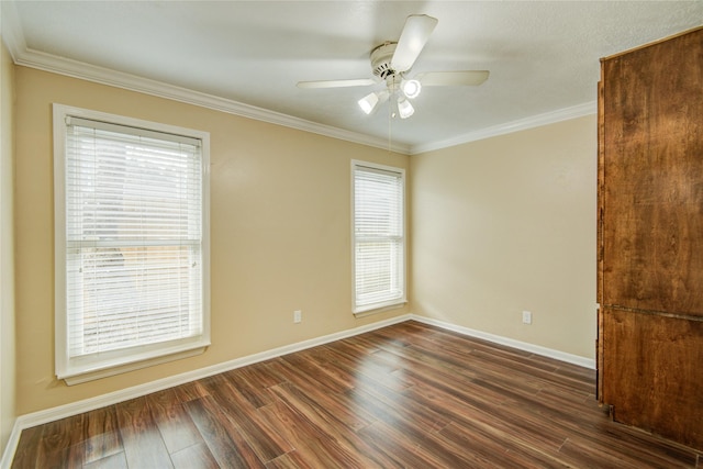 spare room with dark hardwood / wood-style flooring, ornamental molding, and ceiling fan