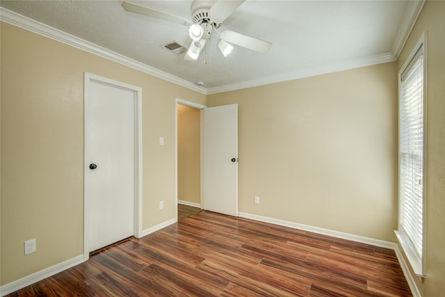 unfurnished bedroom featuring crown molding, ceiling fan, and dark hardwood / wood-style flooring