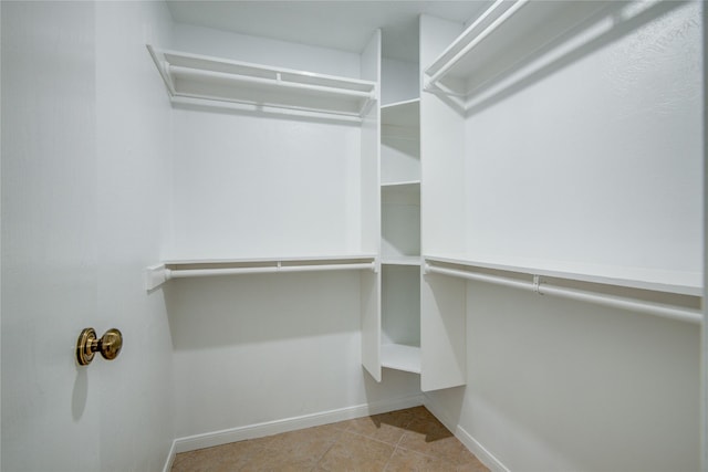 walk in closet featuring light tile patterned floors