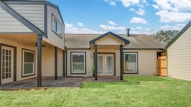 back of house featuring french doors, a patio, and a lawn