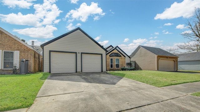 view of front facade featuring a garage, an outdoor structure, and a front yard