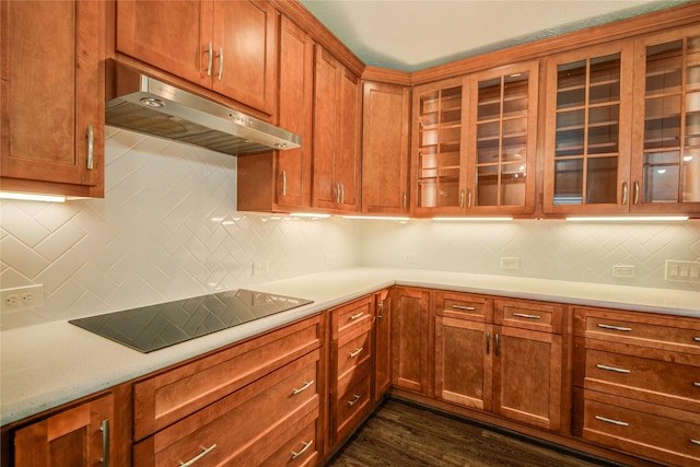 kitchen with dark wood-type flooring, black electric stovetop, and backsplash