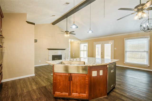 kitchen featuring dishwasher, pendant lighting, sink, and a center island with sink