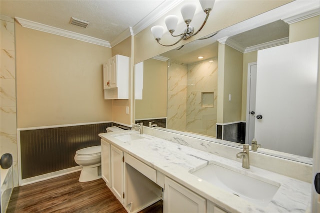 bathroom featuring ornamental molding, toilet, hardwood / wood-style floors, and vanity