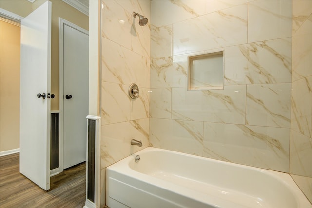 bathroom with hardwood / wood-style flooring and tiled shower / bath