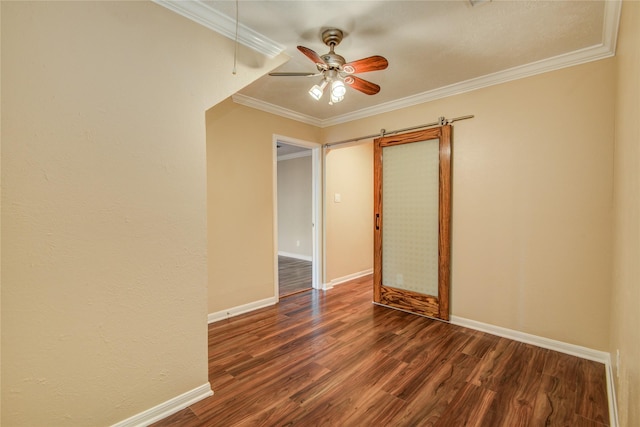 spare room featuring crown molding, dark wood-type flooring, and ceiling fan