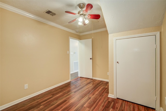 unfurnished room with crown molding, ceiling fan, and dark hardwood / wood-style flooring